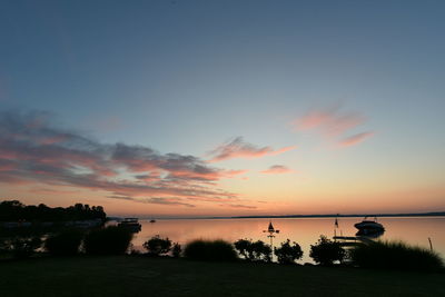 Scenic view of sea against romantic sky at sunset