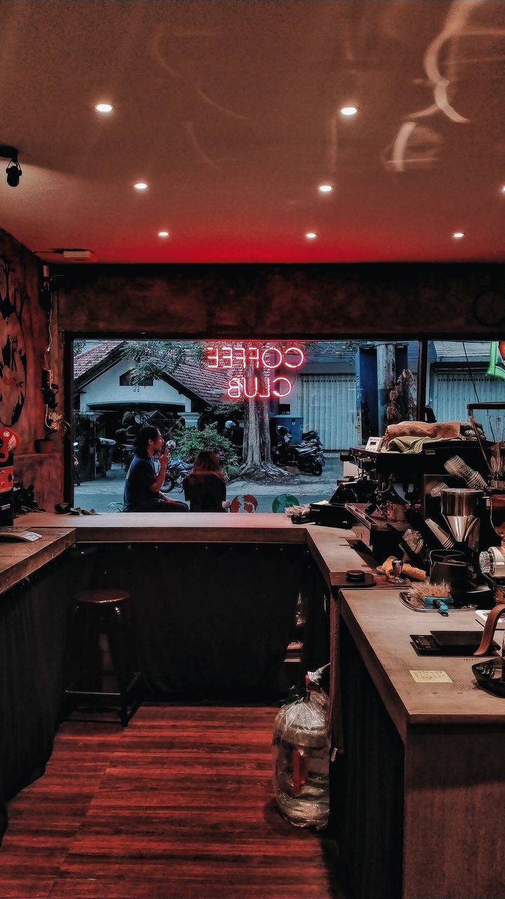 VIEW OF RESTAURANT AND CHAIRS IN ILLUMINATED ROOM