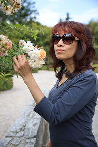 Portrait of beautiful woman with apricose and white flower