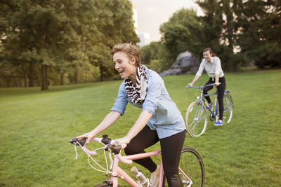 Happy women cycling in central park