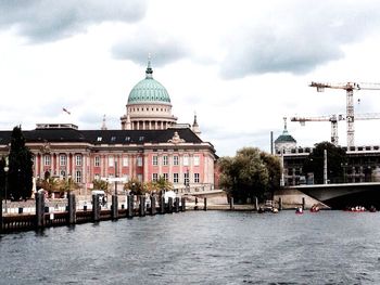 Buildings against cloudy sky