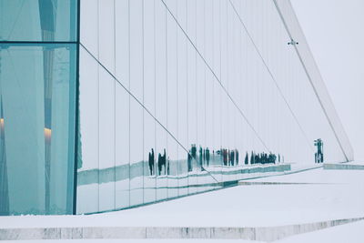 People in modern building against sky