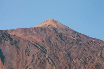 Low angle view of mountain against clear blue sky