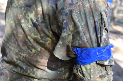 Midsection of soldier in with adhesive tape