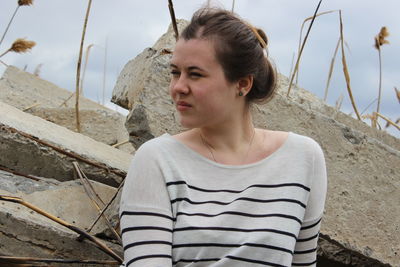 Portrait of young woman looking away at beach