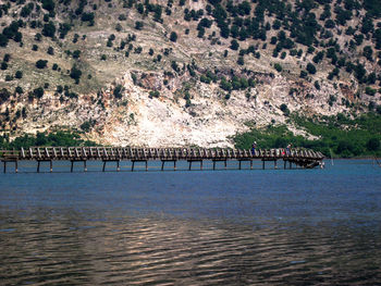 Scenic view of river amidst trees and buildings