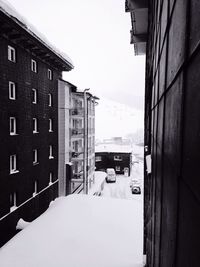 Houses in city against sky during winter