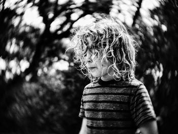 Boy standing in forest