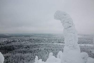 Snow on field against sky during winter