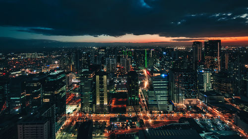 High angle view of illuminated city buildings at night