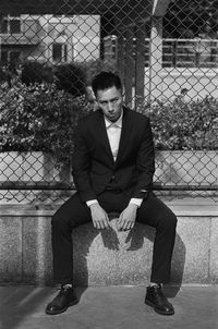 Portrait of young man sitting on bench