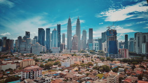 Panoramic view of buildings in city against sky