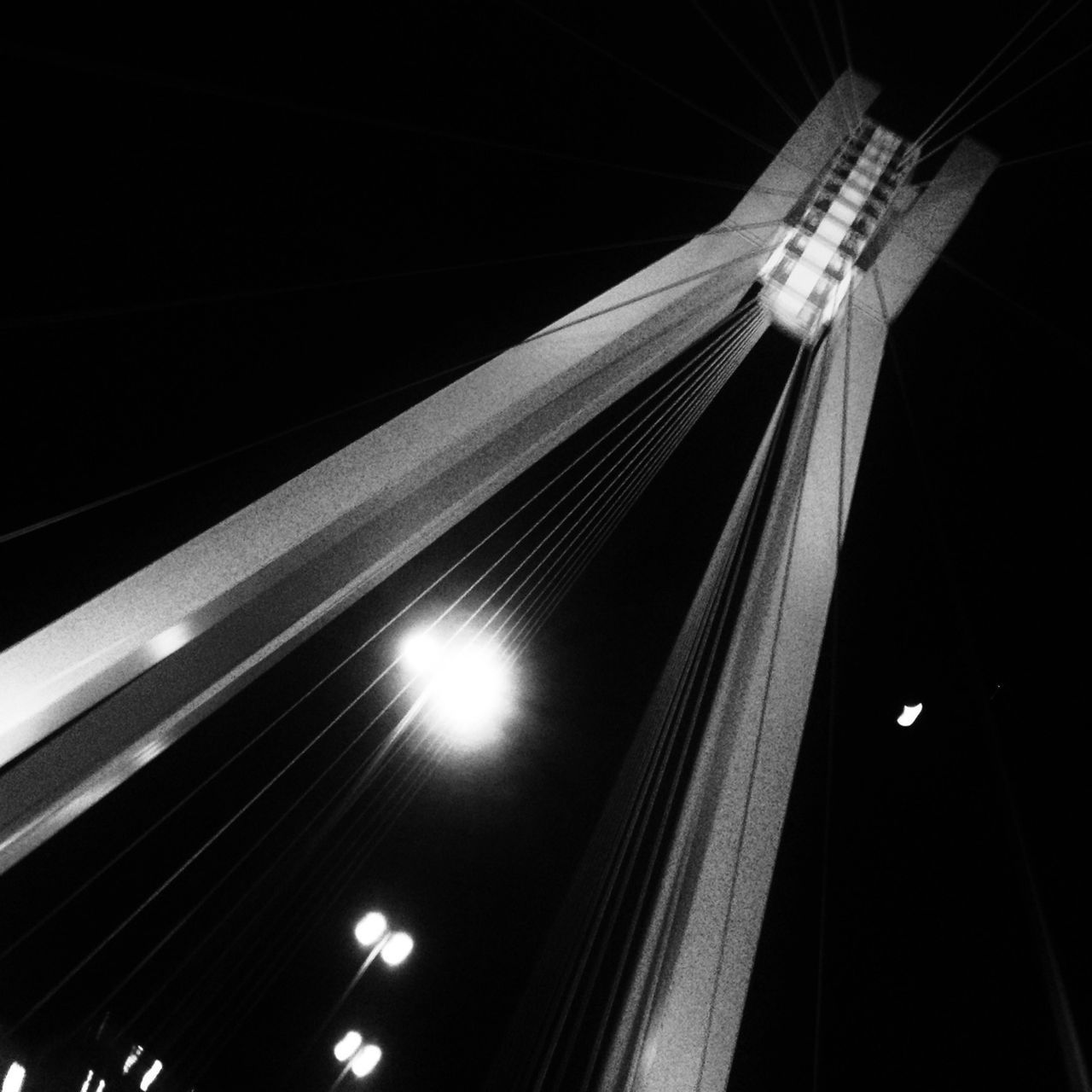 low angle view, night, illuminated, built structure, architecture, connection, transportation, bridge - man made structure, lighting equipment, no people, engineering, railing, modern, outdoors, building exterior, electricity, sky, motion, clear sky