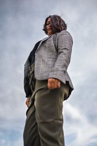 Low angle view of businesswoman standing against sky