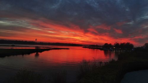 Scenic view of lake against romantic sky at sunset