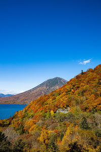 Scenic view of mountains against blue sky