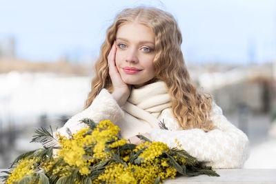 A woman with a bouquet of yellow acacia flowers. spring holiday - march 8, easter, women's day