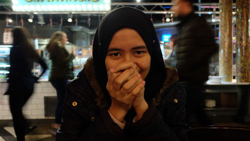 Close-up portrait of young woman wearing warm clothing