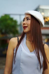 Beautiful woman looking away in city