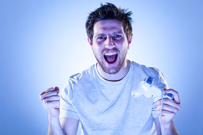 Portrait of man against blue background