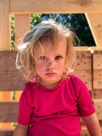 Portrait of cute girl sitting outdoors