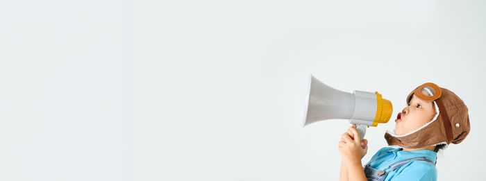 Boy photographing against white background