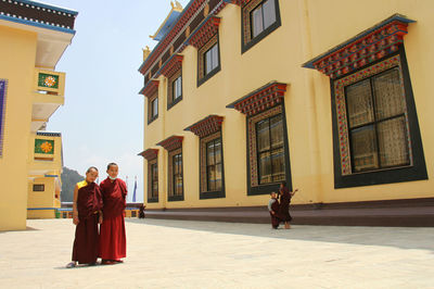 Rear view of people standing outside building