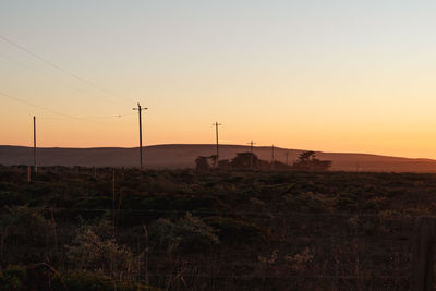 Scenic view of field against sky during sunset