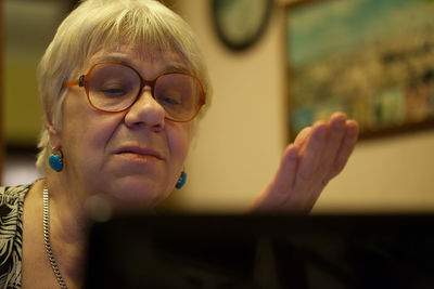 Close-up of senior woman using laptop at home