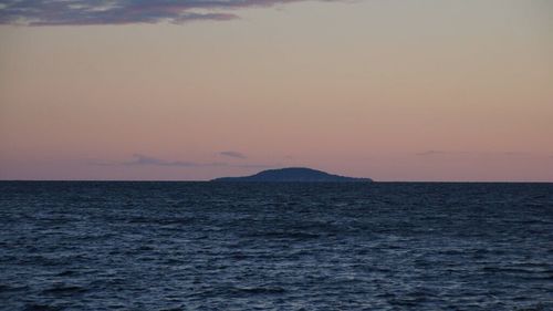 Scenic view of sea against sky at dusk