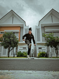 A young girl in hoodie and pants exercising in the midst of pandemic to maintain stamina 