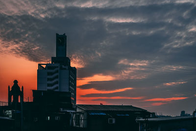 Low angle view of silhouette city against sky during sunset