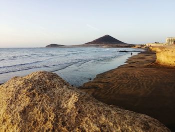 Scenic view of beach against clear sky