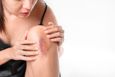 Midsection of woman with hands against white background