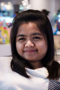 Close-up portrait of smiling young woman