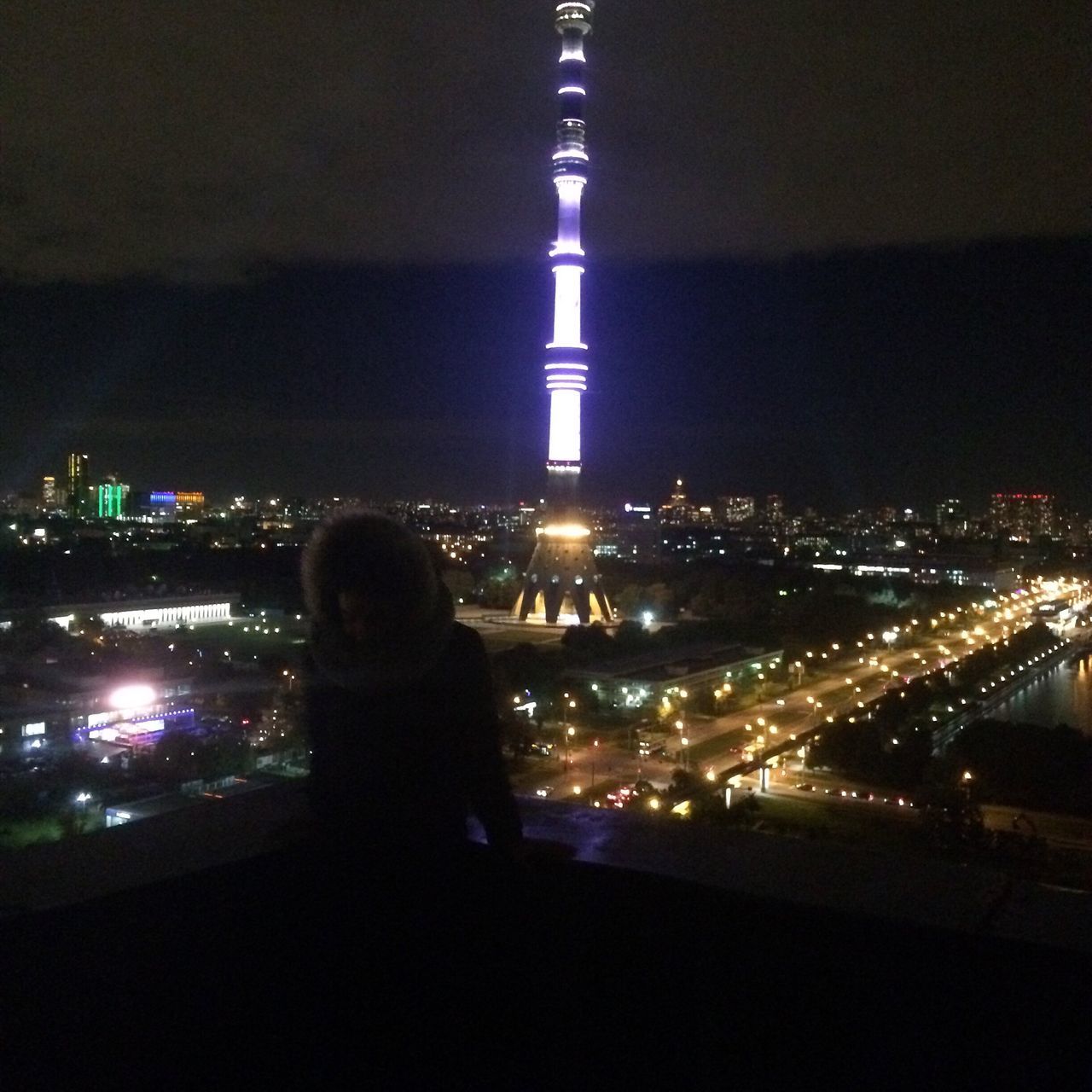 night, illuminated, city, lighting equipment, real people, travel destinations, people, women, urban skyline, cityscape, outdoors, nightlife, adult, skyscraper, one person, sky, adults only