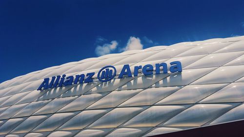 Low angle view of text on building against sky