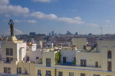 Buildings in city against sky