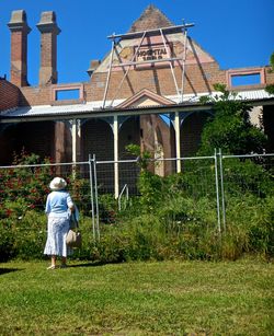 Rear view of woman standing in lawn