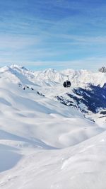 Scenic view of snow covered mountains against sky