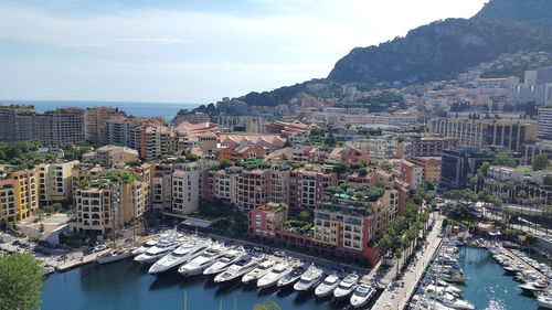 High angle view of buildings by sea against sky