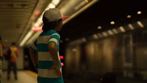 Boy standing at subway station
