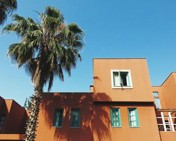 Low angle view of houses against clear sky