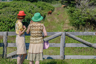 Rear view of woman standing on field