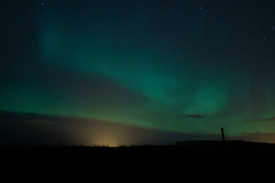 Scenic view of silhouette landscape against sky at night