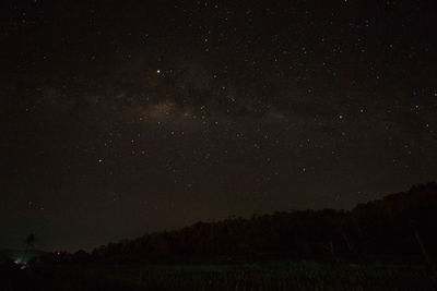 Scenic view of silhouette landscape against star field at night