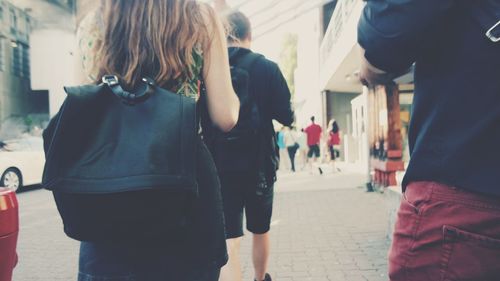 Rear view of woman standing on street