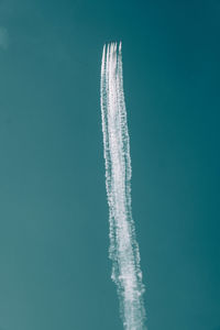 Low angle view of airplane flying against sky