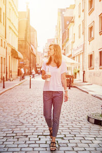 Woman walking on street in city