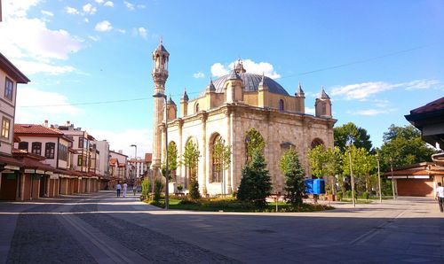 Buildings in city against blue sky